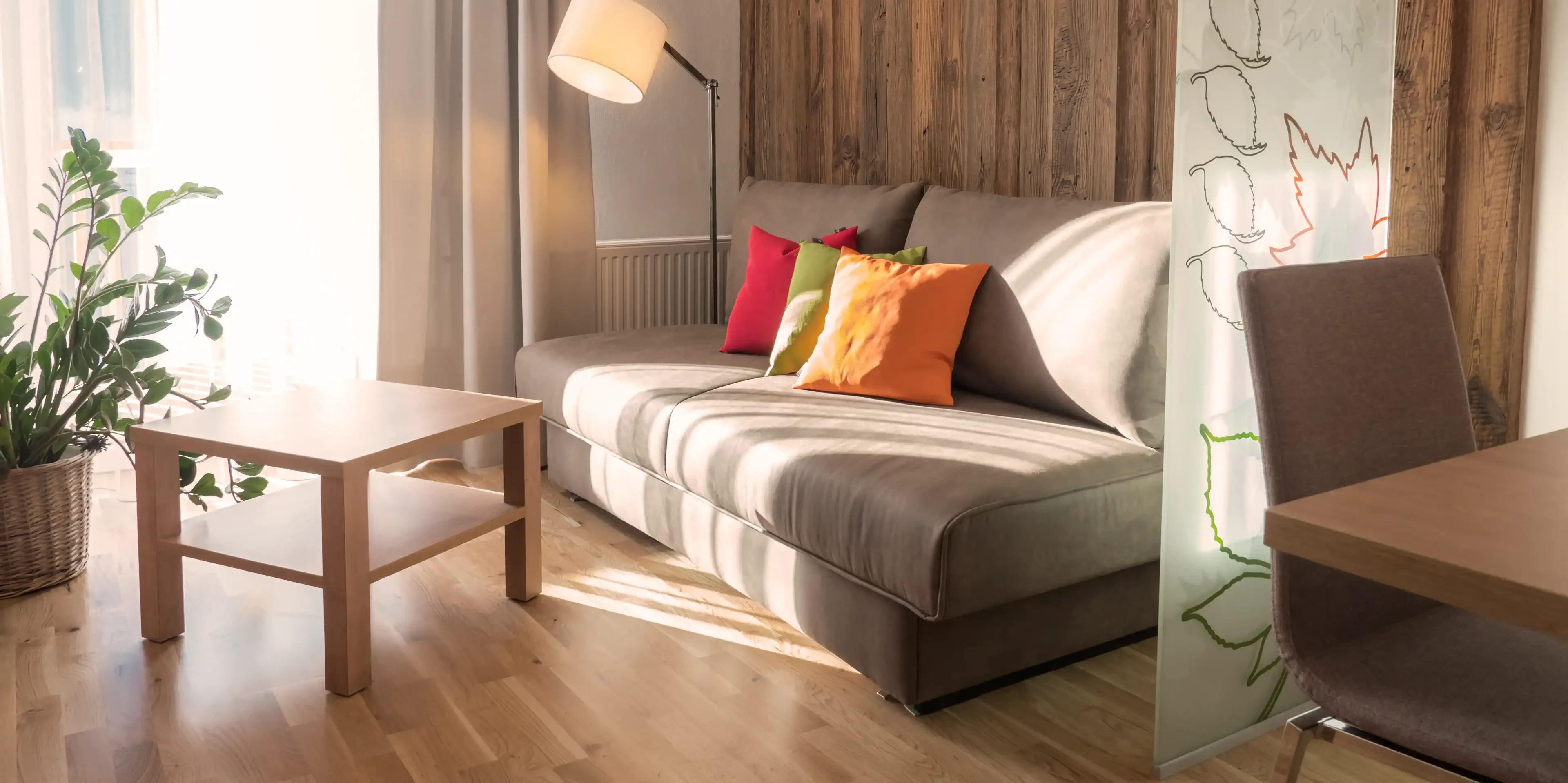 Couch in front of rustic wall unit of the Top Suite apartment